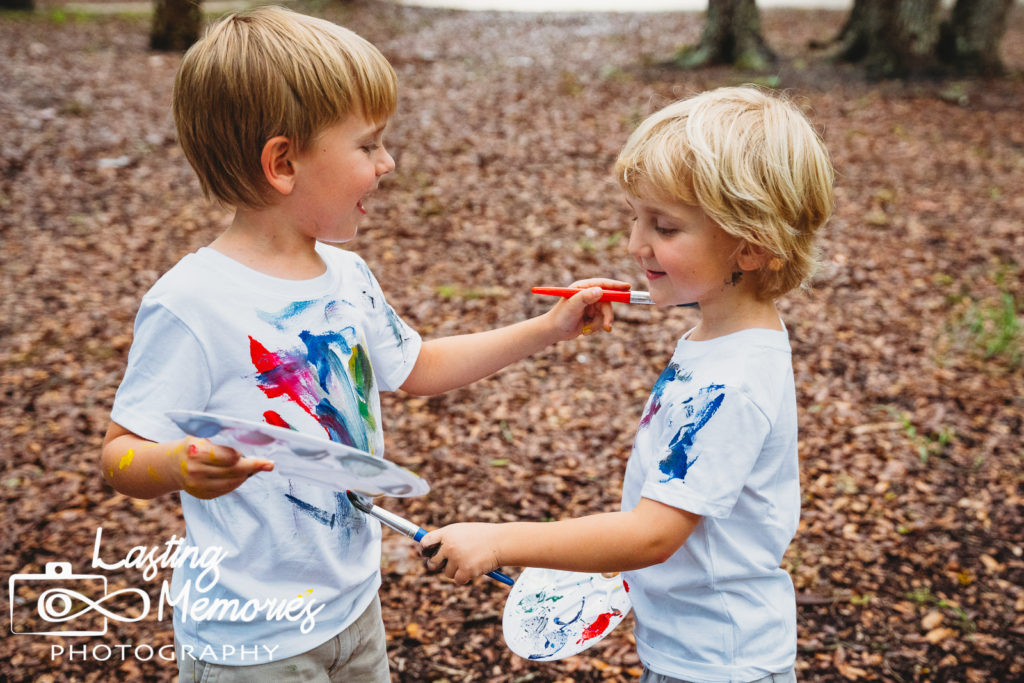 Brothers having fun painting shirts during a mini session