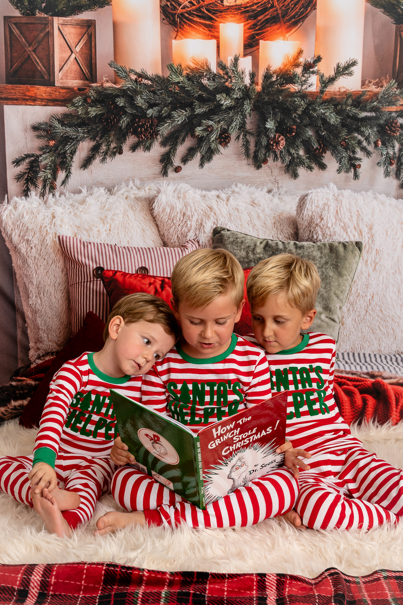 Boys in christmas PJ reading book