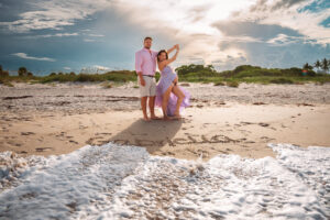 Expecting couple embracing during golden hour at Vero Beach park maternity session